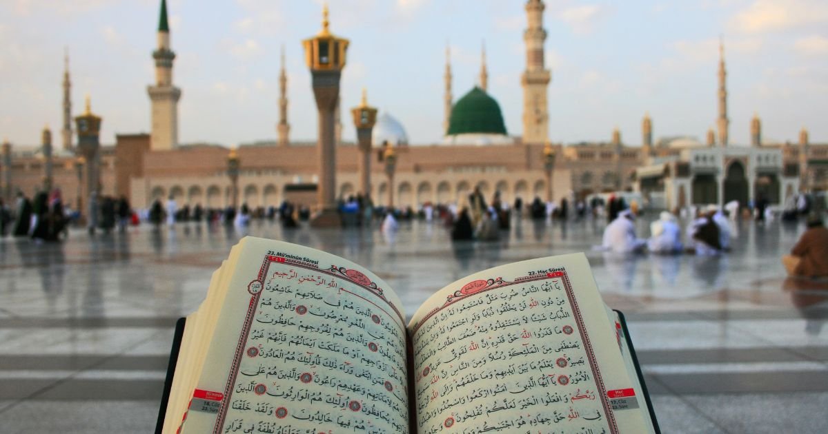 Open Qur'an being read by a pilgrim in the courtyard of Al-Masjid an-Nabawi, Medina. Use our Umrah guide UK for how to perform Umrah and the Umrah checklist UK.