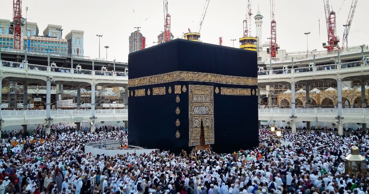 The Holy Kaaba in Mecca surrounded by thousands of pilgrims performing Tawaf, secure your journey today with our cheap Umrah packages UK.